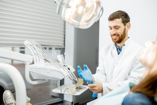 Handsome dentist preparing for the procedure